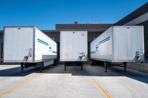 Trailers from a drop-trailer pool parked at distribution centre dock doors