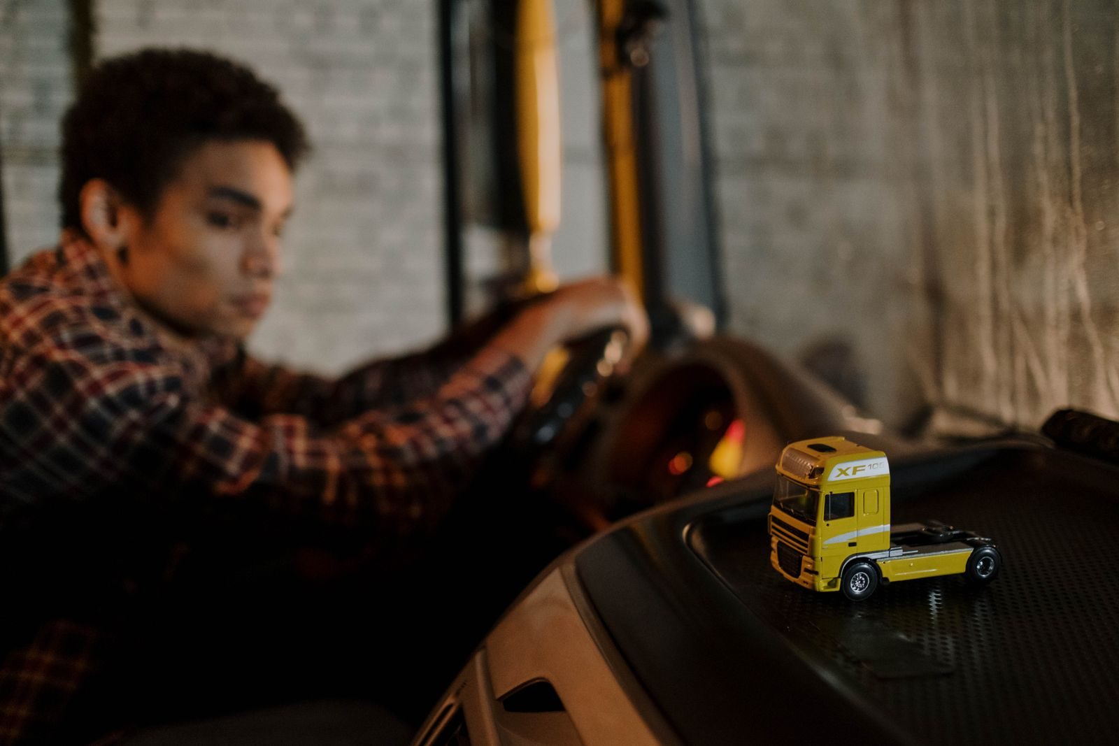 Lorry driver at the wheel in the cab of a truck