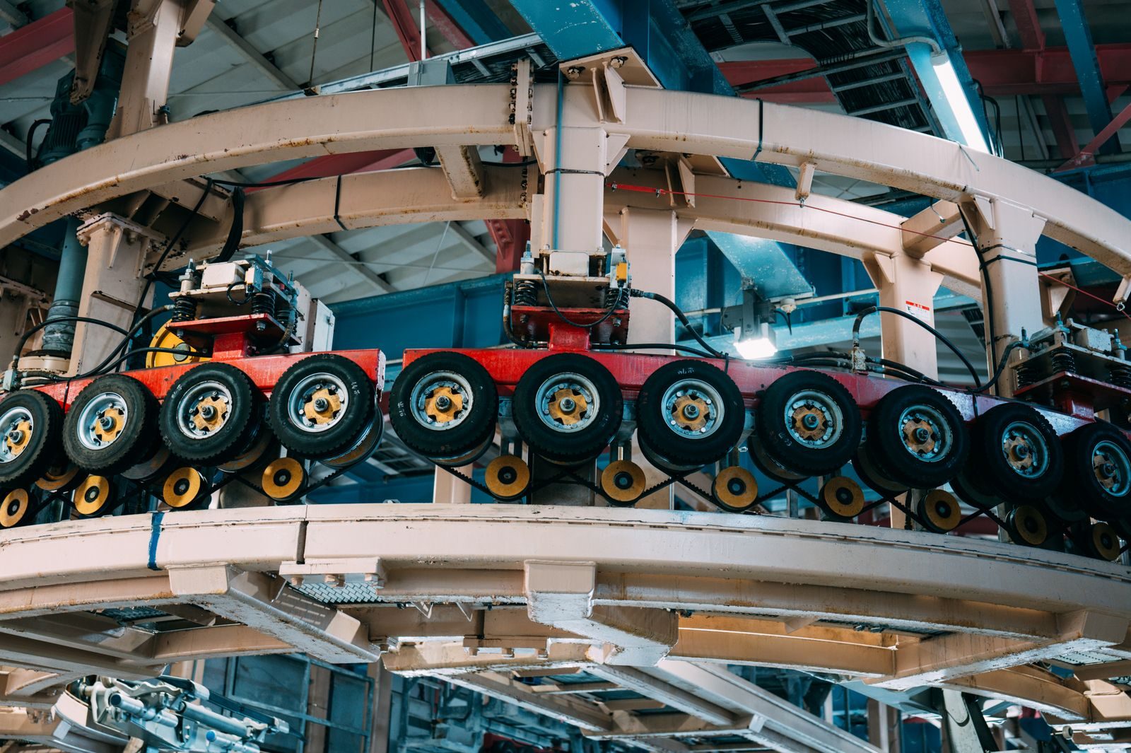 Wheels moving on an overhead conveyor in a car assembly plant