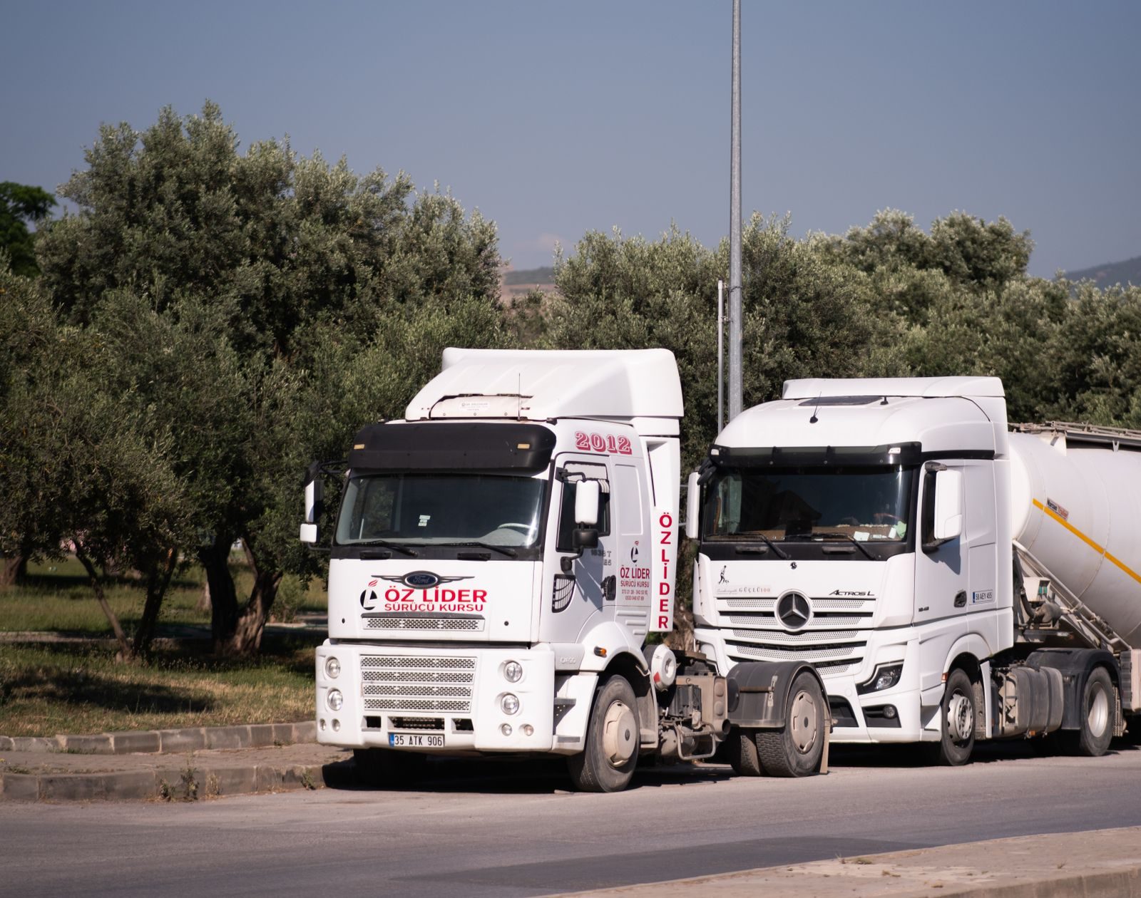 Two European tractor units parked side by side between loads